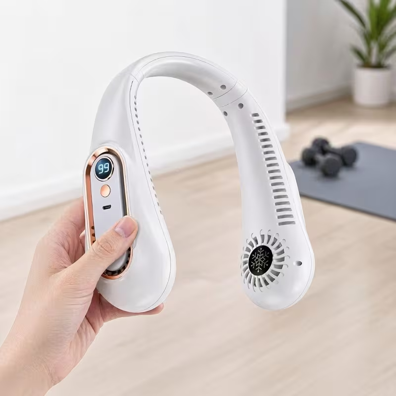 White portable neck fan held in hand showing the LED digital display